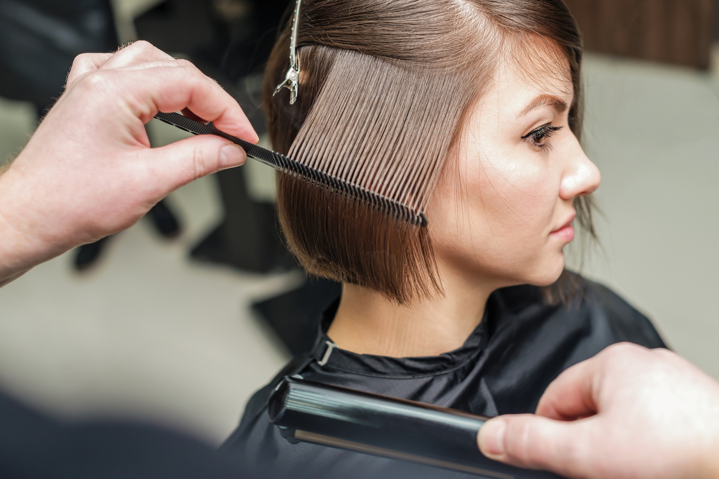 Hair salon. Woman haircut. Cutting.